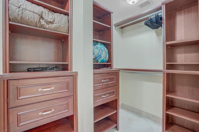 a bathroom with a sink double vanity granite tub shower and a mirror