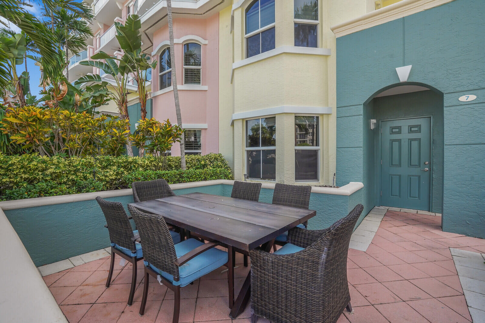 2051 Southeast 3rd Street, Unit TH7 Deerfield Beach, FL 33441 - Photo 4 of 48 a view of a patio with table and chairs and potted plants