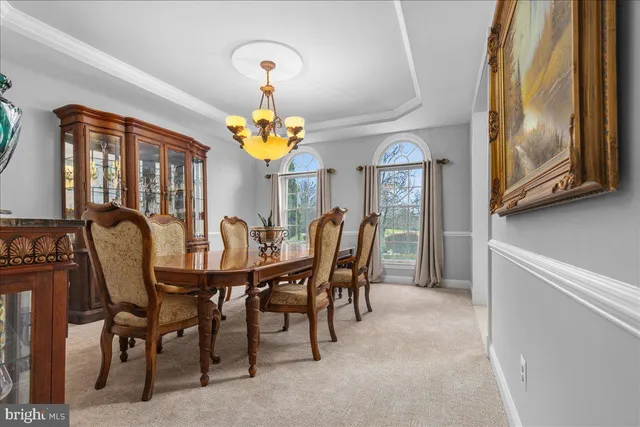 a spacious bedroom with a bed a mirror and a window