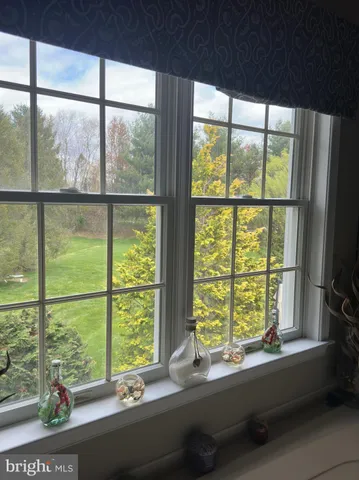 a view of a big building with a big yard and large trees