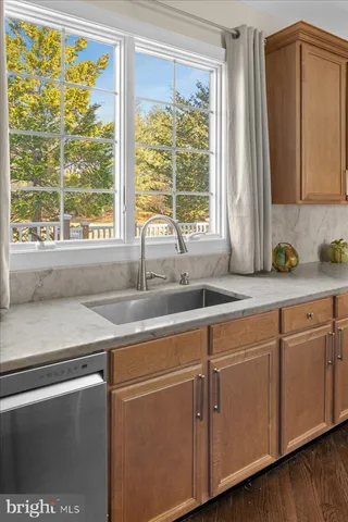 a kitchen with a table chairs sink and cabinets