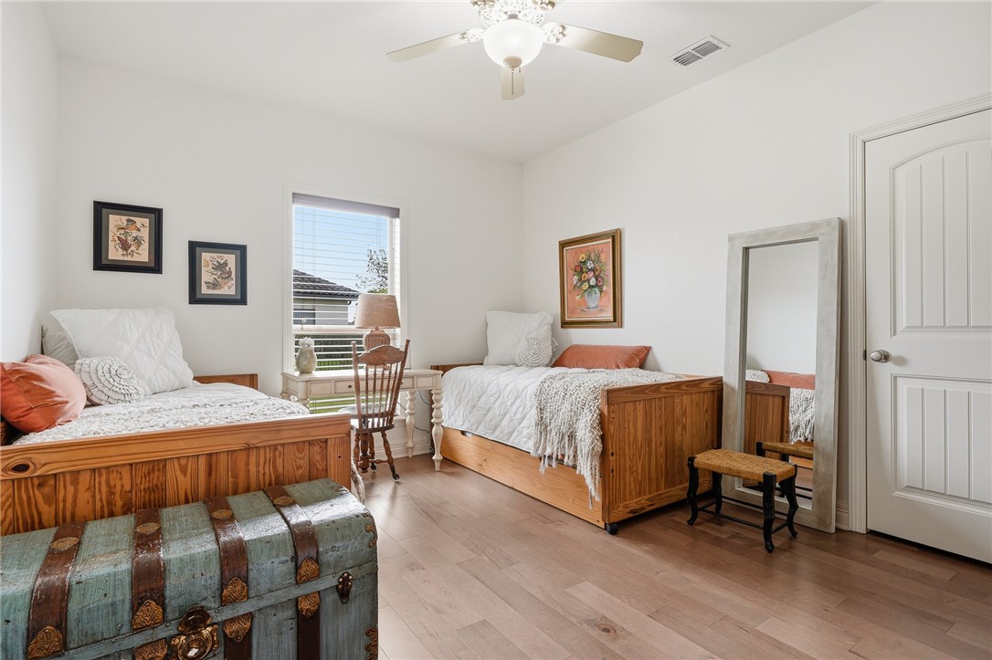 8710 KIng Ranch Drive Corpus Christi, TX 78414 - Photo 21 of 38 a bedroom with two beds and wooden floor