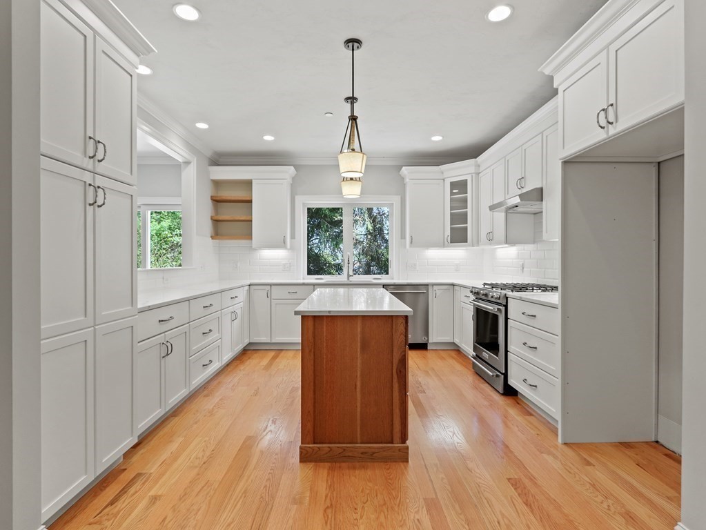 an open kitchen with wooden floor