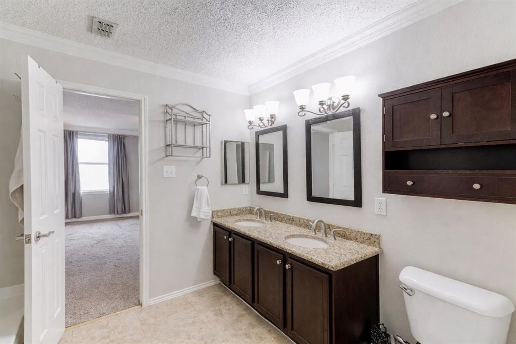 3601 McClintick Road McKinney, TX 75070 - Photo 18 of 24 a bathroom with a granite countertop sink and a mirror