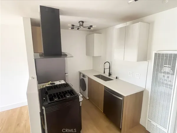 a kitchen with a sink and a stove top oven