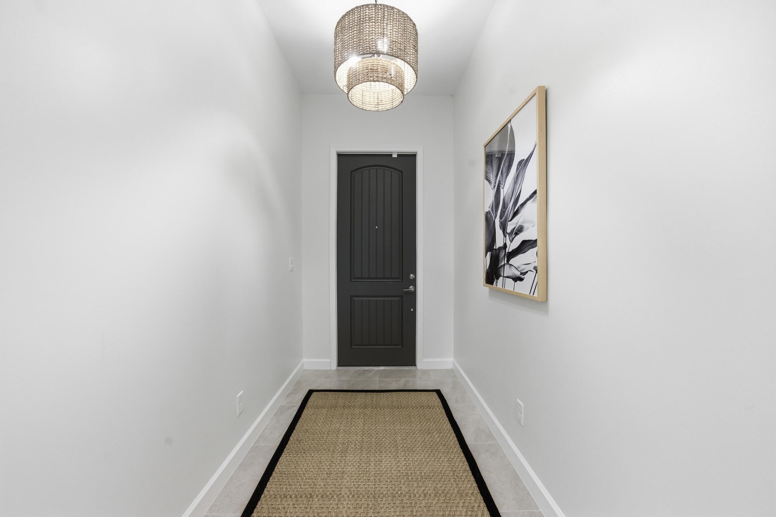 19230 Rolling Acres Road Loxahatchee, FL 33470 - Photo 46 of 58 a view of a hallway with wooden floor