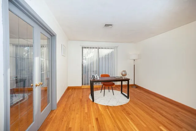 a dining room with furniture and wooden floor