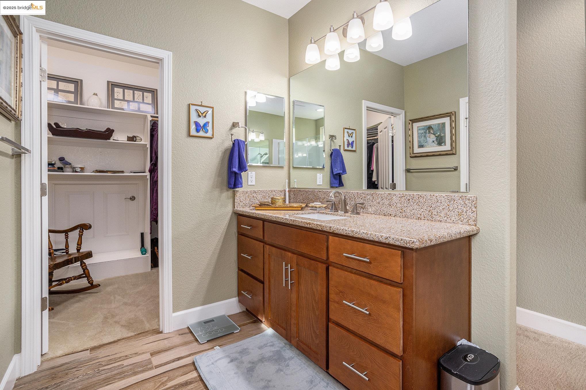 299 Marks Road Rio Vista, CA 94571 - Photo 17 of 39 Bathroom featuring a spacious closet, a textured wall, vanity, and light wood-style flooring