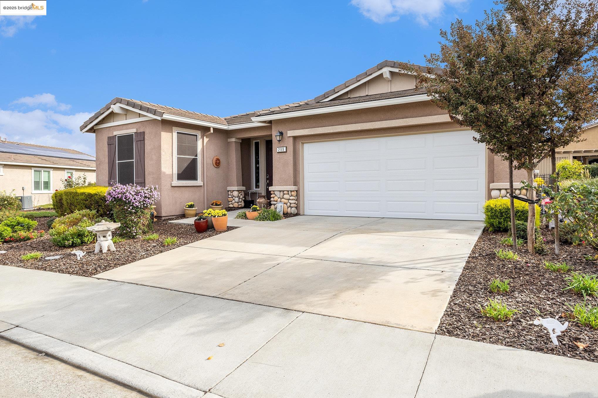 299 Marks Road Rio Vista, CA 94571 - Photo 4 of 39 Ranch-style house featuring a tiled roof, concrete driveway, stucco siding, and a garage