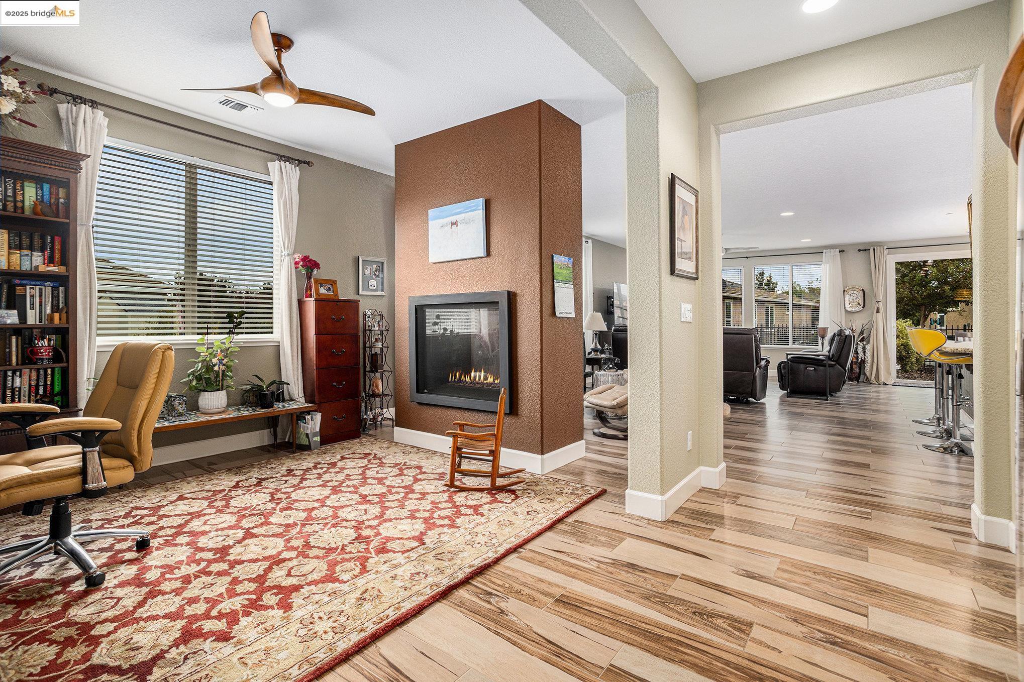299 Marks Road Rio Vista, CA 94571 - Photo 5 of 39 Office space with a multi sided fireplace, light wood finished floors, a ceiling fan, and recessed lighting