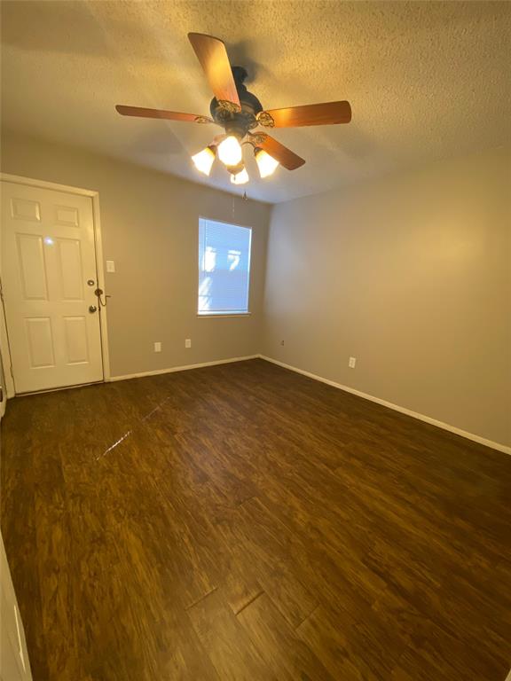 1409 Kilpatrick Court, Unit D Cleburne, TX 76033 - Photo 4 of 10 an empty room with a empty space and a ceiling fan