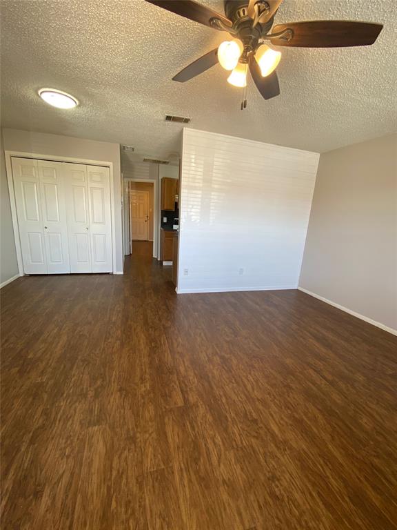 1409 Kilpatrick Court, Unit D Cleburne, TX 76033 - Photo 6 of 10 wooden floor in an empty room with a window