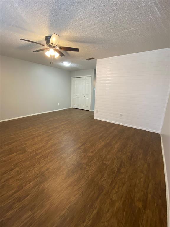 1409 Kilpatrick Court, Unit D Cleburne, TX 76033 - Photo 7 of 10 an empty room with a window and a ceiling fan