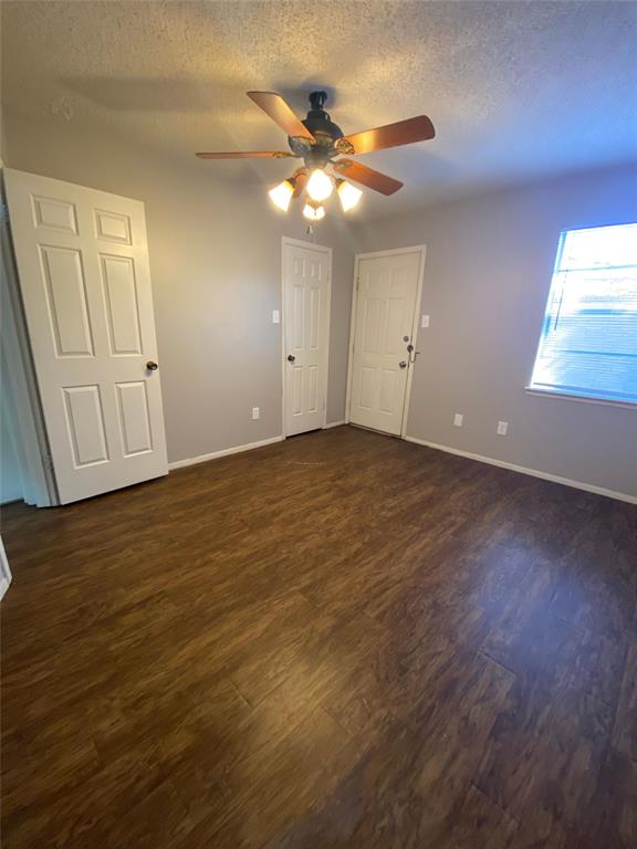 1409 Kilpatrick Court, Unit D Cleburne, TX 76033 - Photo 9 of 10 a view of an empty room with wooden floor and a window