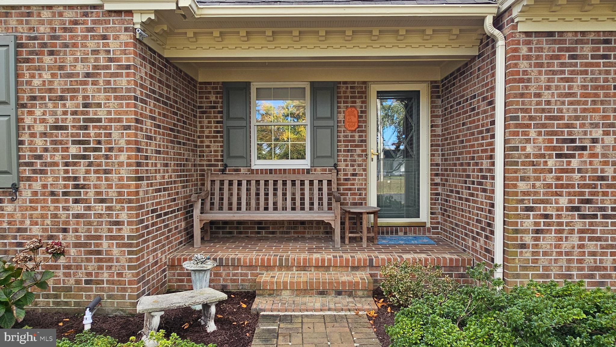 930 Johnson Road Salisbury, MD 21804 - Photo 12 of 69 a view of a brick house with a bench and potted plants