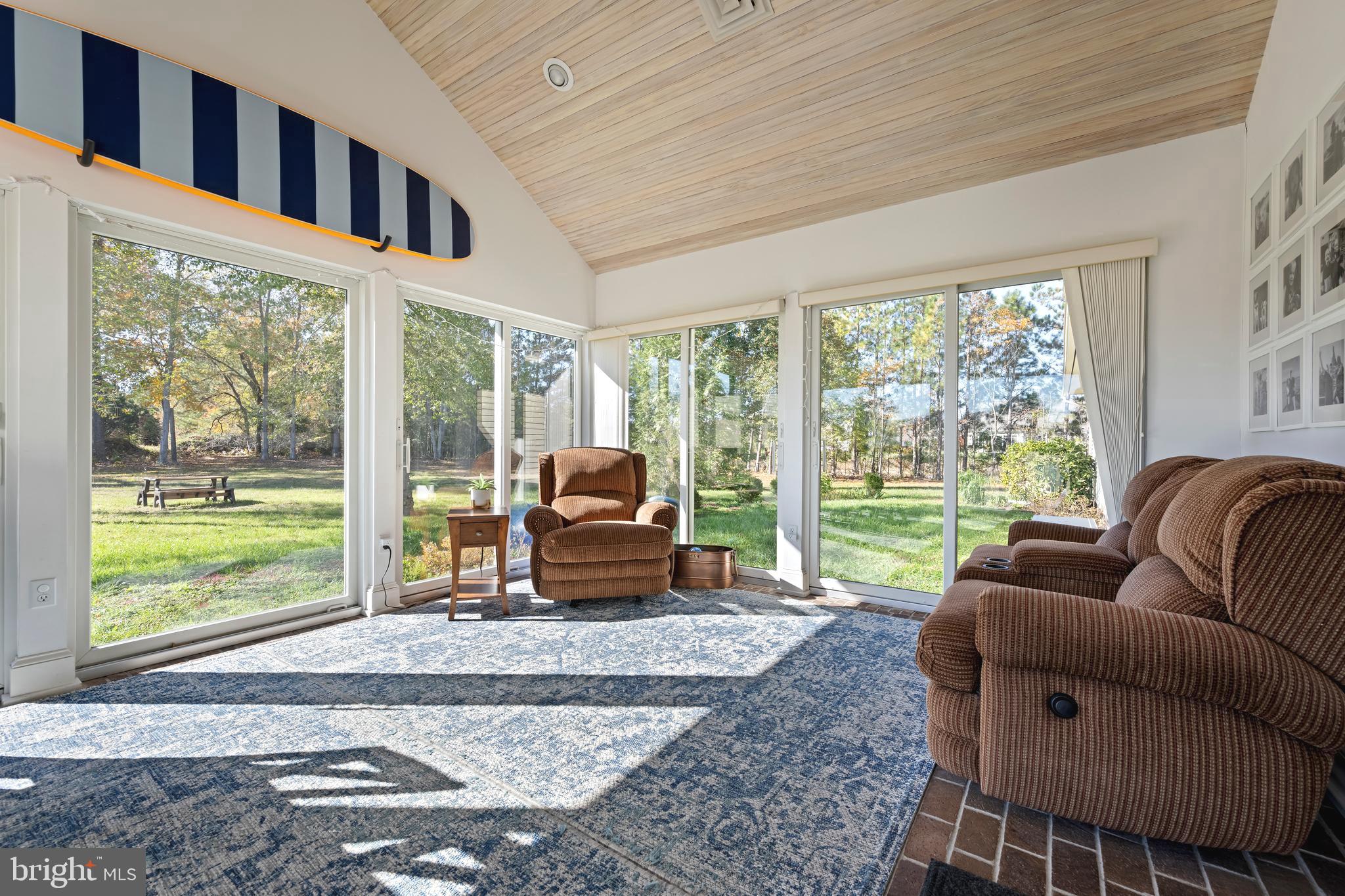 930 Johnson Road Salisbury, MD 21804 - Photo 25 of 69 a living room with furniture a flat screen tv and floor to ceiling window