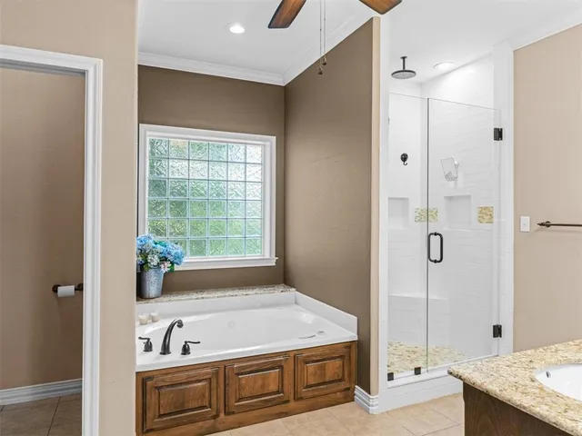 a bathroom with a tub a sink and a shower