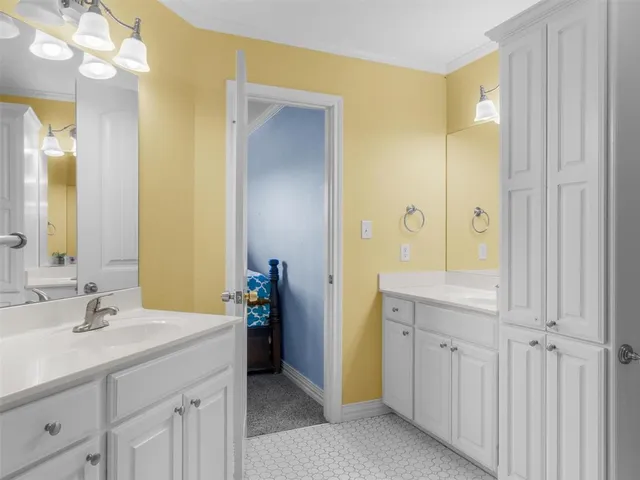 a spacious bathroom with a double vanity sink a mirror and a shower