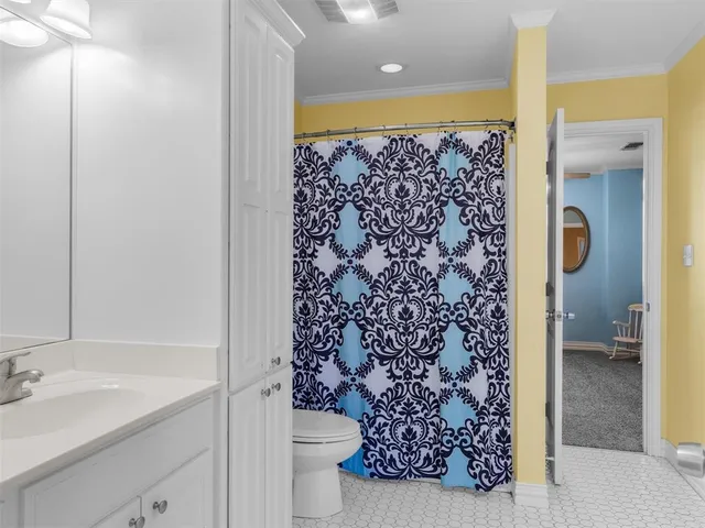 a bathroom with a shower curtain and a sink