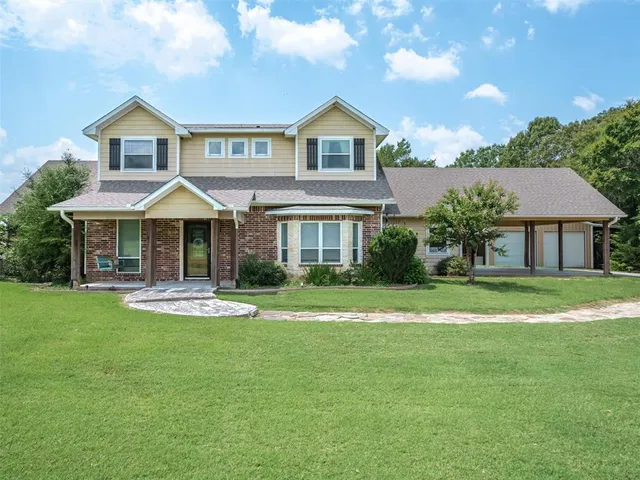 a front view of a house with a yard table and chairs
