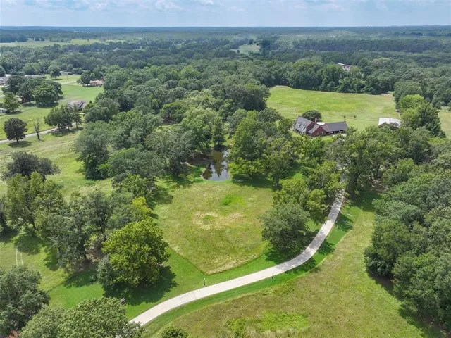 an aerial view of a residential houses with outdoor space and garden
