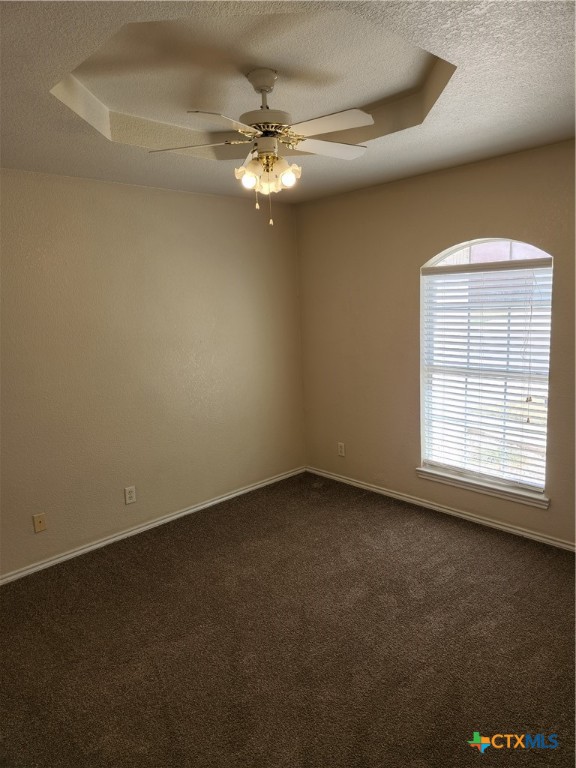 3407 Woodrow Drive Killeen, TX 76549 - Photo 6 of 10 an empty room with a chandelier fan and windows