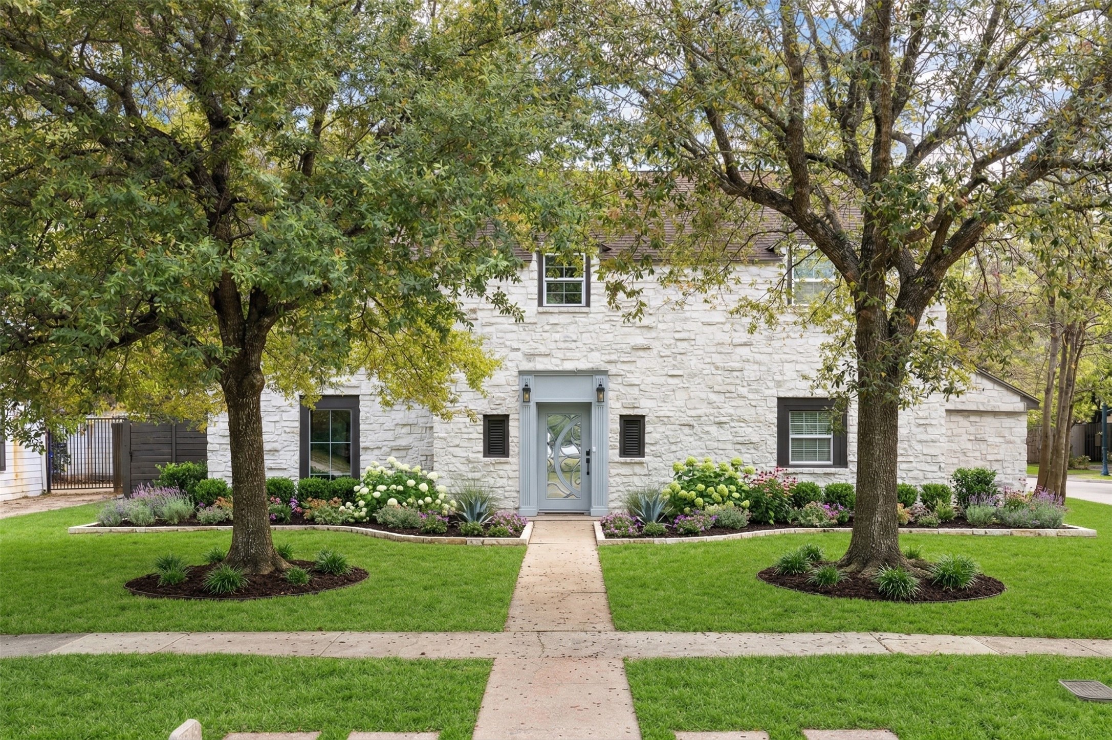 3071 Locke Lane Houston, TX 77019 - Photo 1 of 44 a front view of a house with a yard and an trees