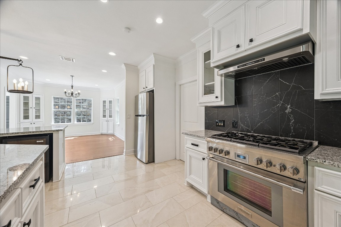 3071 Locke Lane Houston, TX 77019 - Photo 16 of 44 a kitchen with stainless steel appliances a stove a refrigerator and a cabinets