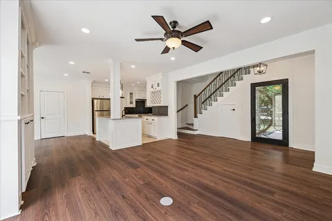 a view of a kitchen with wooden floor and a kitchen