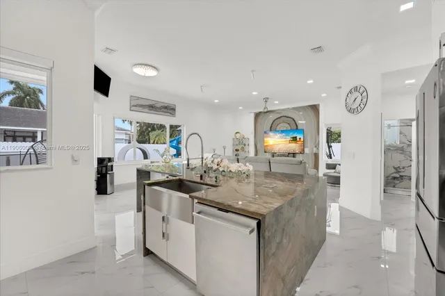 a view of living room with granite countertop furniture and a flat screen tv