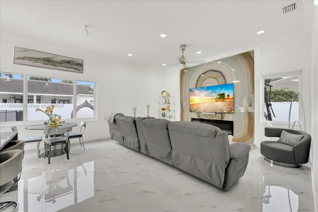 a living room with furniture and a large window