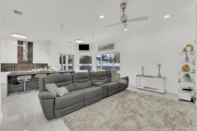 a living room with furniture and kitchen view