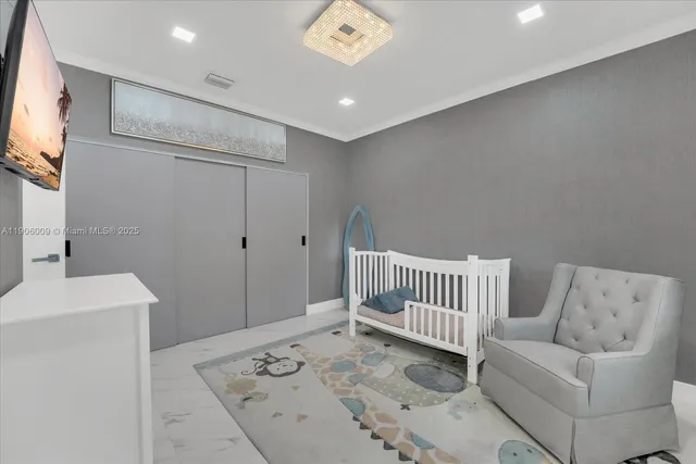 a view of a hallway with a couch and a flat screen tv