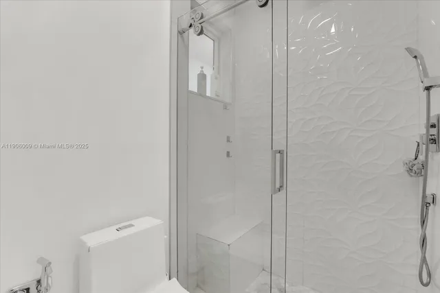 a bathroom with a shower and toilet