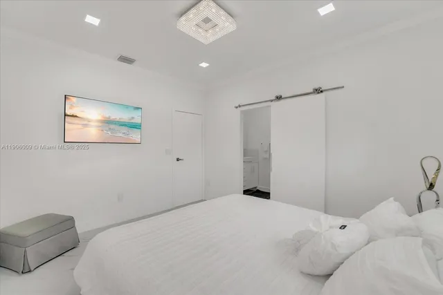 a bedroom with a bed and a couch