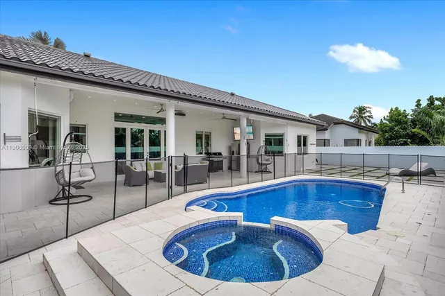 a view of a house with swimming pool and sitting area