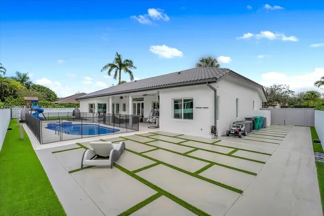 a swimming pool with outdoor seating and yard