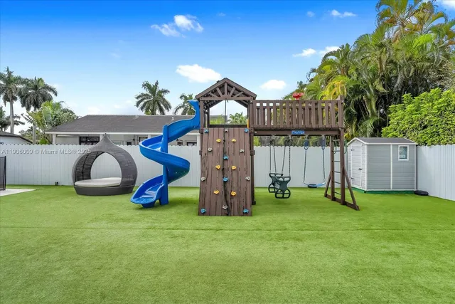 a view of an house with backyard space and a slide