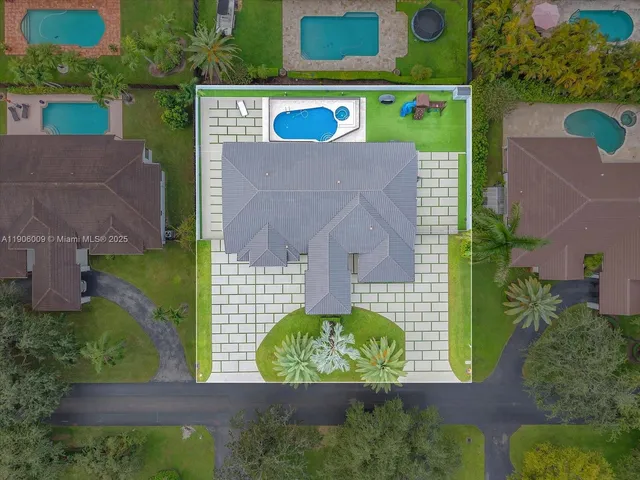 an aerial view of a house with a yard