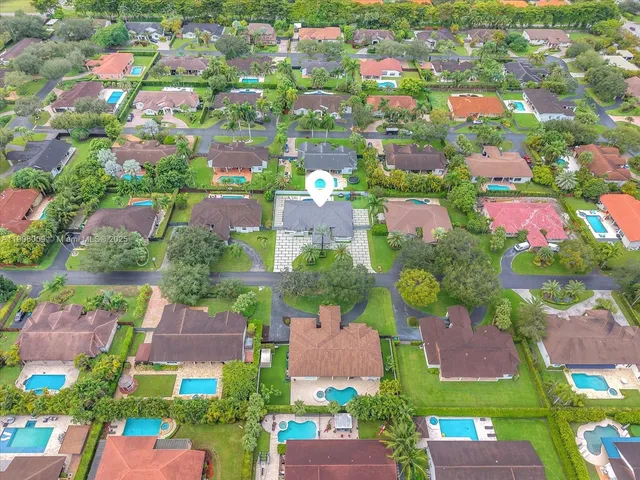 an aerial view of multiple houses with yard
