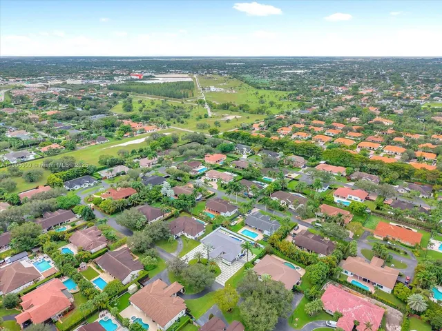 an aerial view of residential houses with outdoor space and street view