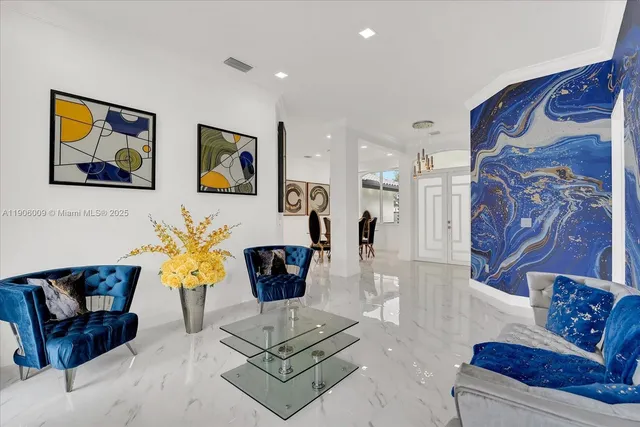 a living room with furniture and painting on the wall