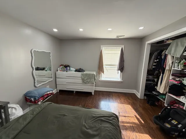 a bedroom with furniture and a window