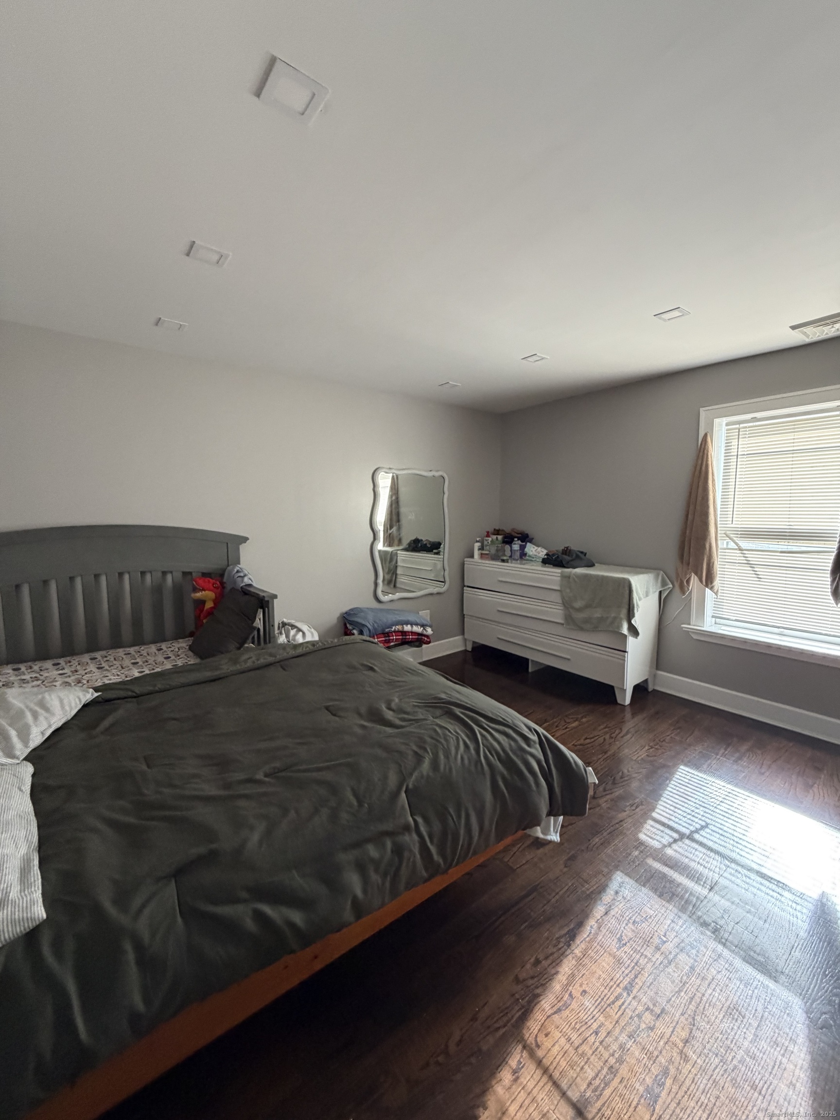 2964 State Street, Unit 2 Hamden, CT 06517 - Photo 12 of 16 a bedroom with a bed and a window