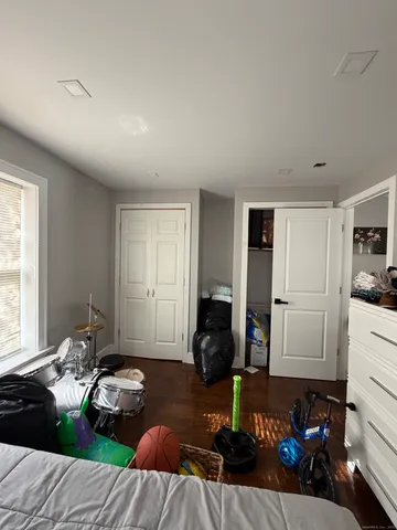 a bedroom with furniture and a window