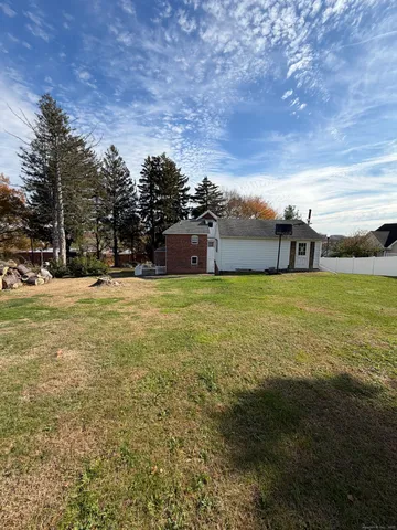 a view of a big yard with an outdoor seating