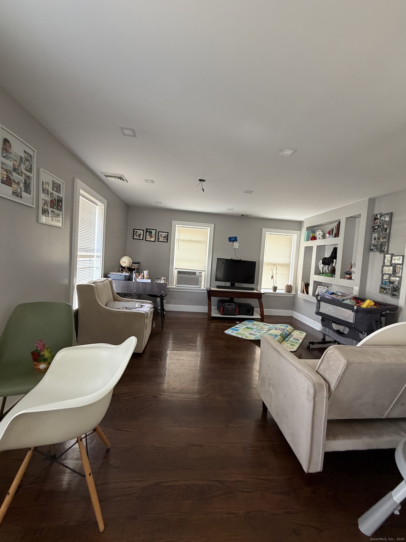 2964 State Street, Unit 2 Hamden, CT 06517 - Photo 5 of 16 a living room with furniture a rug a lamp and a window