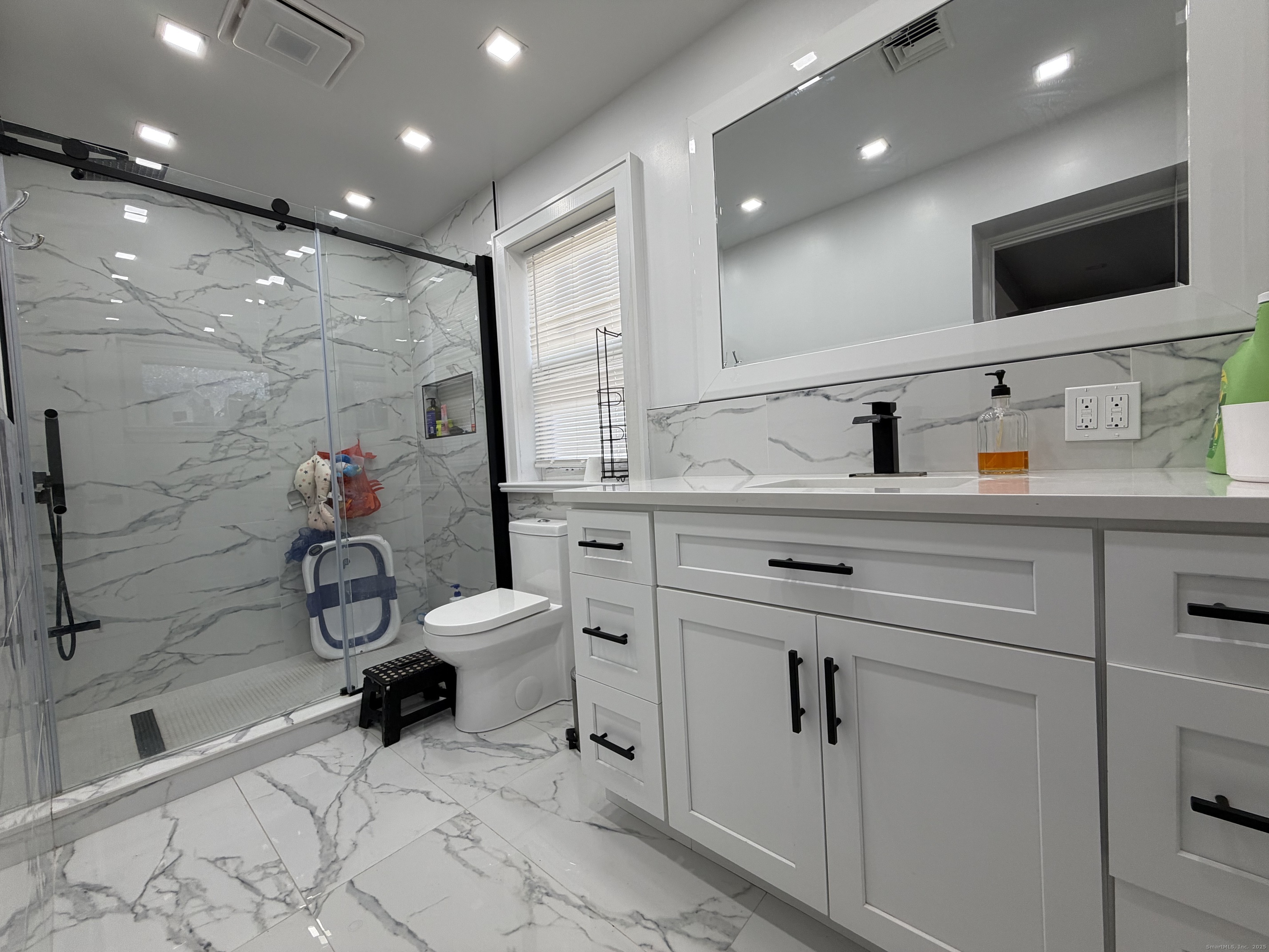 2964 State Street, Unit 2 Hamden, CT 06517 - Photo 8 of 16 a bathroom with a toilet sink double vanity and mirror