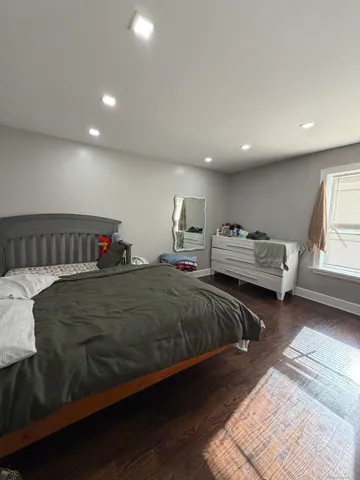 a spacious bedroom with two beds and a couch