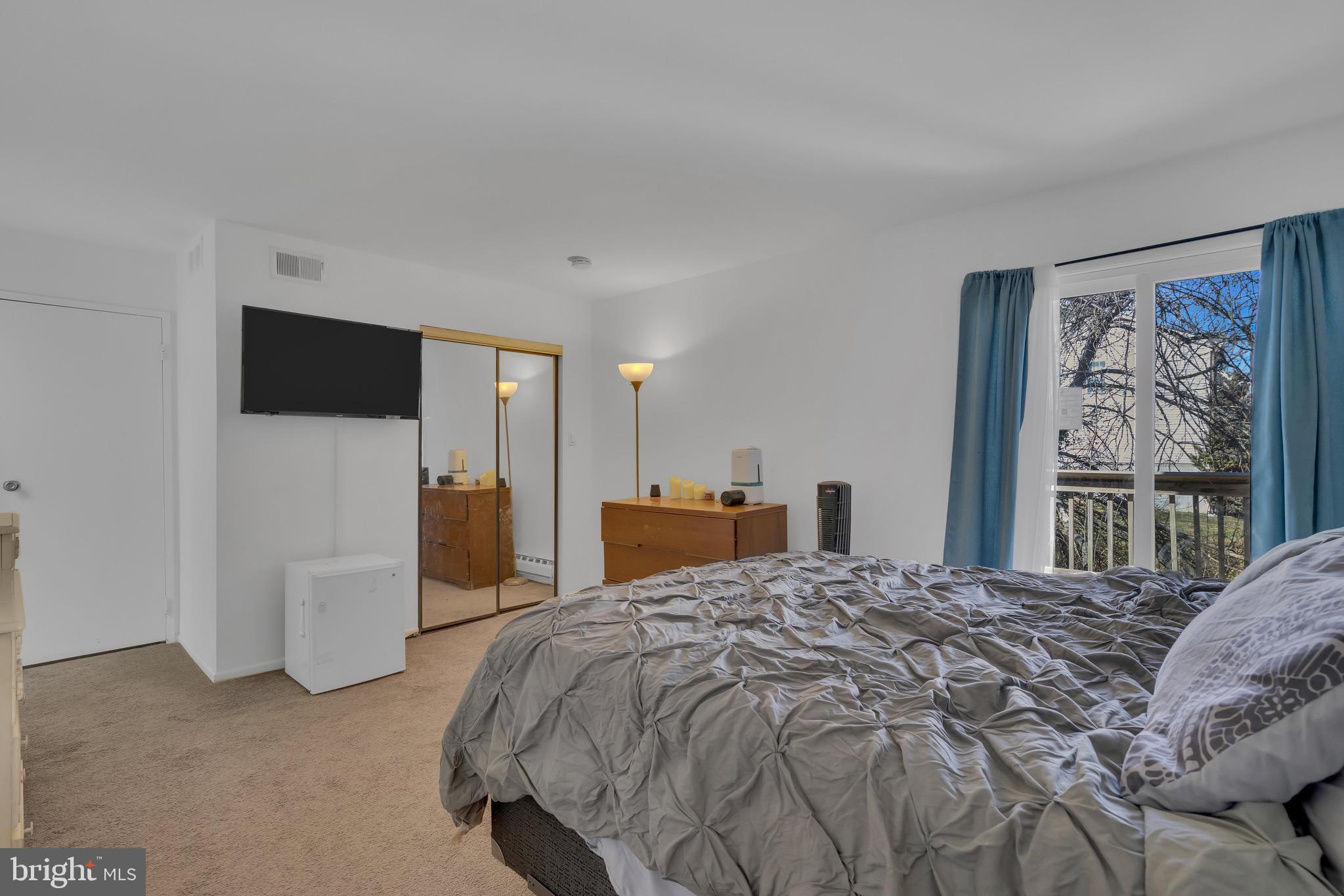 1802 Bromley Estate Pine Hill, NJ 08021 - Photo 18 of 26 a bedroom with a large bed and a flat tv screen on dresser